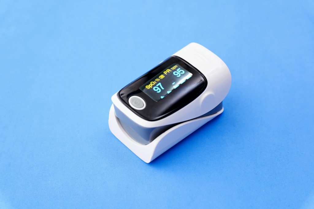 Pulse oximeter isolated a blue background