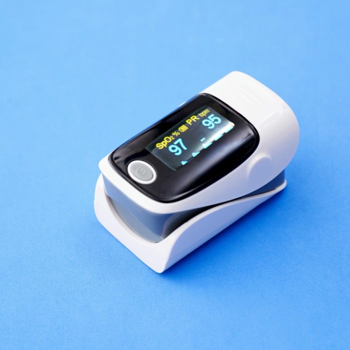 Pulse oximeter isolated a blue background