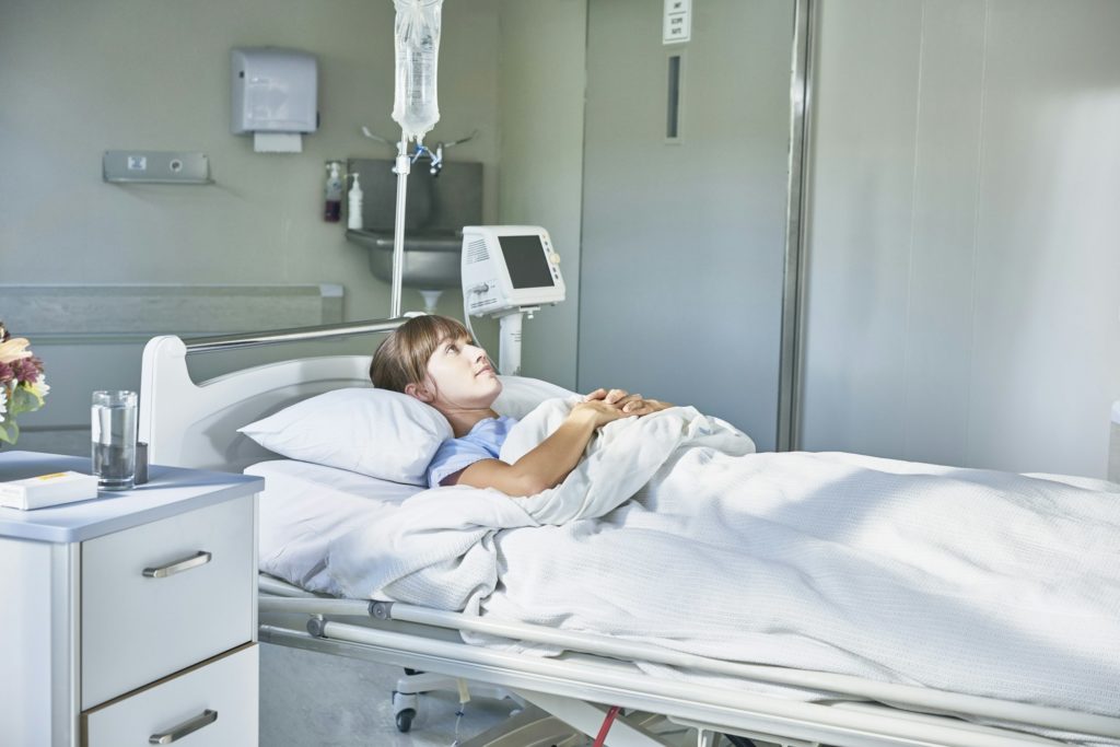 Woman laying down in hospital bed